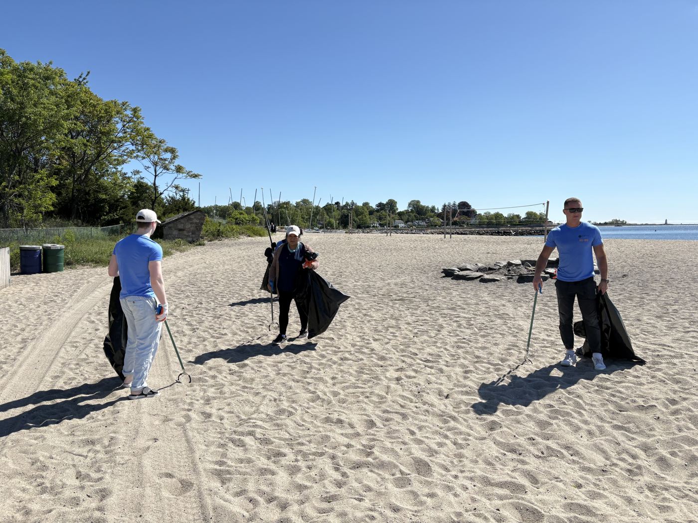 Team members picking up litter on the beach